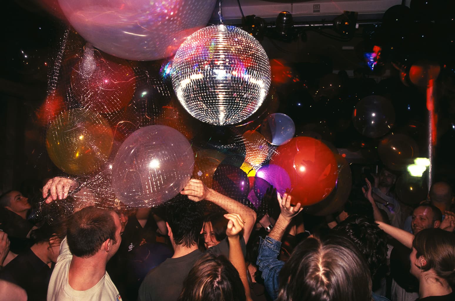 People on Dancefloor, dancing under Big Glitter Ball and balloons, Loft Party, 93 Feet East, Brick Lane, London, 2001